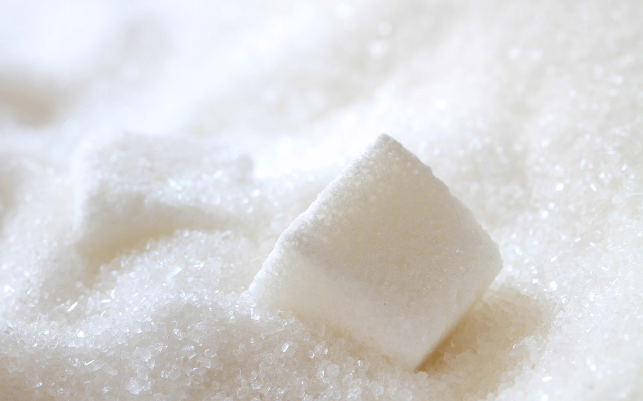 A close up of sugar cubes on top of white ground